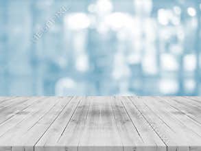Empty white table top on blurred background from shopping mall,space for montage product