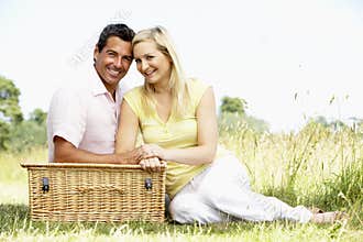Young couple having picnic in countryside