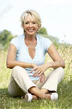 Portrait of mature woman sitting in countryside