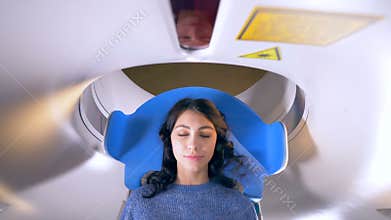Hospital emergency MRI image scan. Woman lays in Magnetic Resonance Image device during medical exam. 4K.