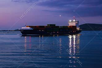 Cargo ship sailing at night