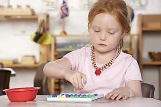 Young Girl Playing at Montessori/Pre-School