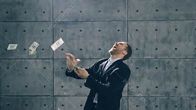 Man in formal suit dancing and throwing money