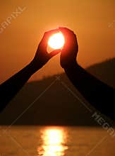 Two hands take a sun