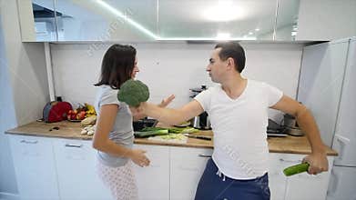 Morning at home happy young couple newly wed dancing listening to music in kitchen wearing pajamas. slow motion