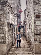 An old woman walking in the alley