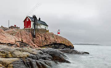 Historical building and small lighthouse in the area of FemÃ¶re, Sweden