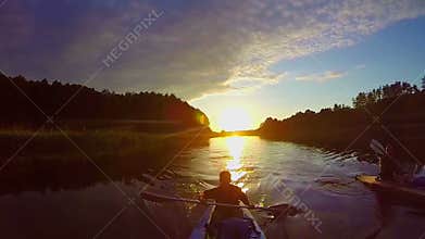 Travelers kayaking at sunset, breathtaking view, sport, slow-mo