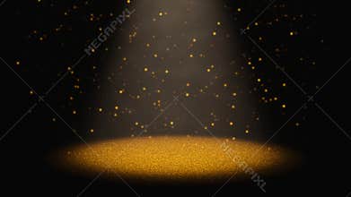 Twinkling golden glitter falling through a cone of light on a stage
