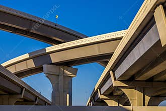 Section of elevated highway with several levels against a bright blue sky in Houston, Texas