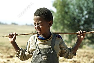 Portrait Ethiopian Oromo boy with stick