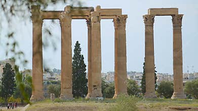 Many tourists go sightseeing around ruins of ancient building, summer vacation