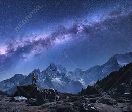 Space with Milky Way, man on the stone and mountains