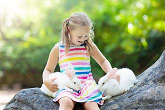 Child with rabbit. Easter bunny. Kids and pets.
