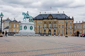 Palace with a monumental equestrian statue of Amalienborg`s founder, King Frederik V, Copenhagen, Denmark