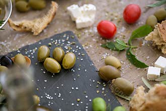 Top view antioxidant green olives in black plate