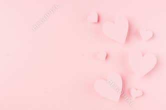 Valentines day background with hearts flying on pink paper, copy space.