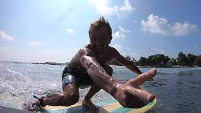 Surfer rides crystal clear ocean wave
