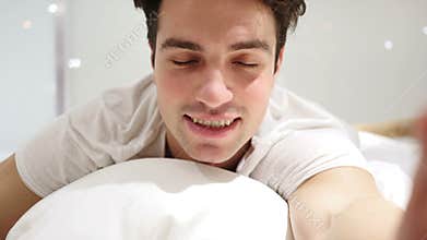 Online Video Chat by Man Lying in Bed, Close Up