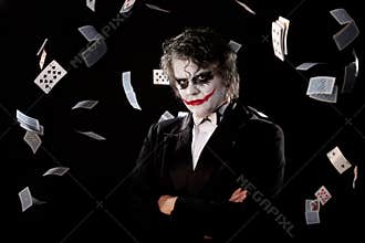 Man in an image of a joker with fly cards