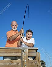 Senior Couple Reel in Fish