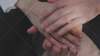 Detail of two lovers joining hands