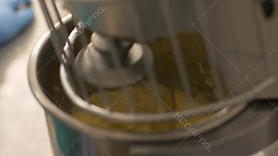 Close up automatic mixer kneading dough in bakeryhouse