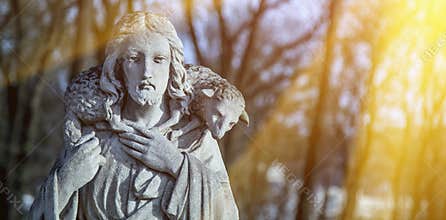 Ancient statue of Jesus Christ is the Good Shepherd with the los