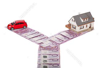 Model house, car and five hundred euro banknote crossroad