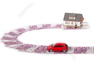 Model house, car and five hundred euro banknote road