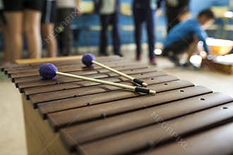 Xylophone and drumsticks in a music class with children