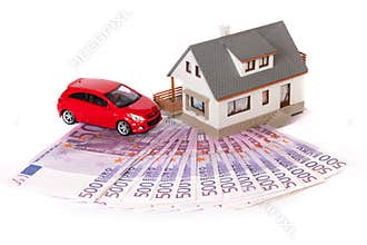Model house, car and five hundred euro banknote
