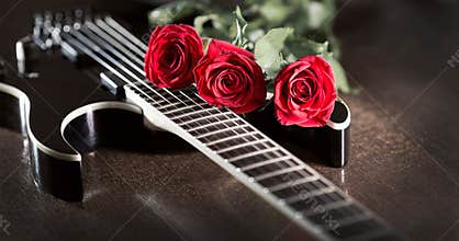 Three roses on black guitar