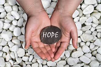 Hope word in stone on hand