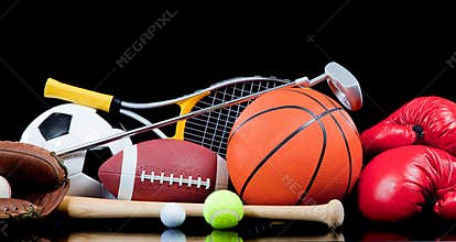 Assorted sports equipment on black