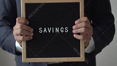Word Savings from Letters on Text Board in Anonymous Businessman Hands