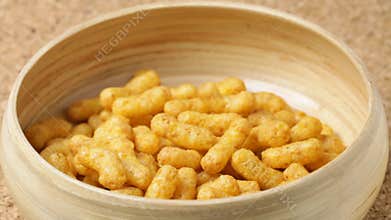 Close up of nut chips falling into bowl