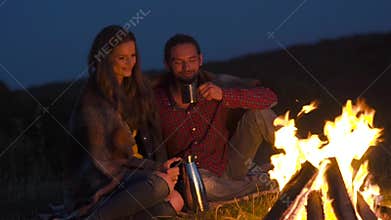 Romantic weekend. Couple in love near bonfire in nature