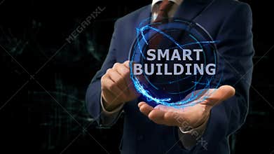 Businessman shows concept hologram Smart building on his hand