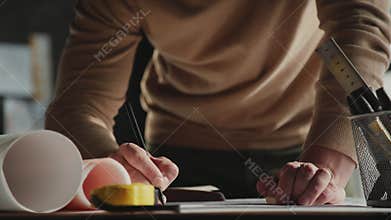 Architect working on blueprint with spesial tools and pencil, close up