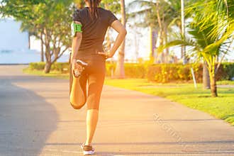 Healthy Life. Asian fitness woman runner stretching legs before run outdoor workout in the park