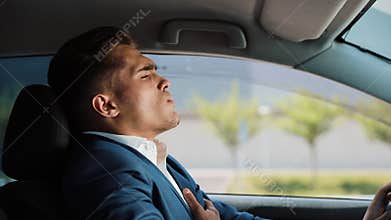 Tired and stressed businessman is sitting in the car. Man having headache. Stress, bankruptcy, bad news, pain