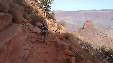 Sporty Man Hiking On A Footpath Trail In Grand Canyon National Park