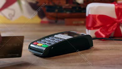 Holiday gift shopping. Man buying packing present with red ribbon