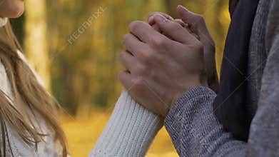 Husband kissing wife hands on outdoor date, careful love attitude to partner