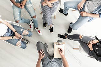 Top view of a group therapy session for teenagers struggling wit