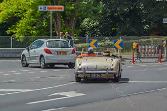 Old couple driving classic car
