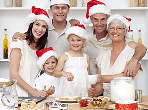 Children baking Christmas cakes with their family