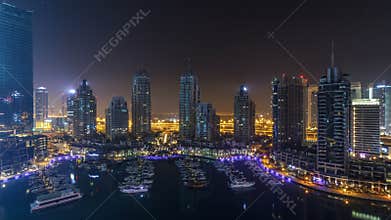 Dubai Marina all night timelapse, Glittering lights and tallest skyscrapers during a clear evening