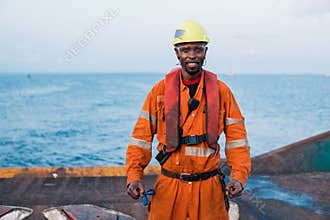 Seaman AB or Bosun on deck of offshore vessel or ship , wearing PPE